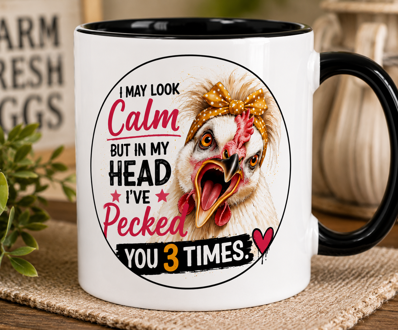 Close-up of a white 15 oz ceramic mug with black handle featuring Lucy the Silkie chicken and the humorous saying "I May Look Calm But In My Head I've Pecked You 3 Times," showcasing the vibrant artwork and glossy ORCA-coated finish on a rustic farmhouse table.