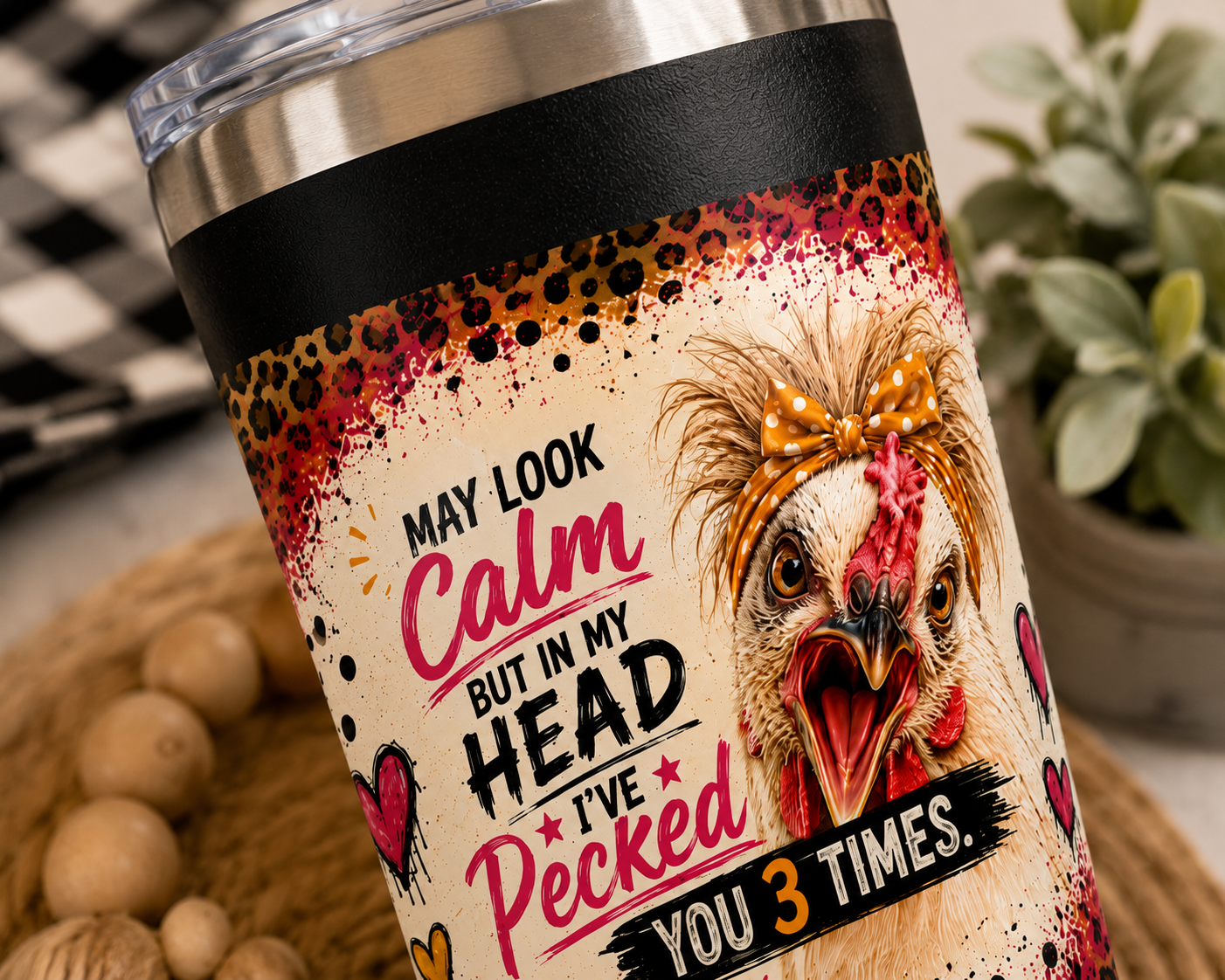 Close-up of the "I May Look Calm, But in My Head I've Pecked You 3 Times" artwork on a 22oz insulated stainless steel travel tumbler featuring a colorful chicken illustration, leopard print accents, and vibrant farmhouse-inspired design details.